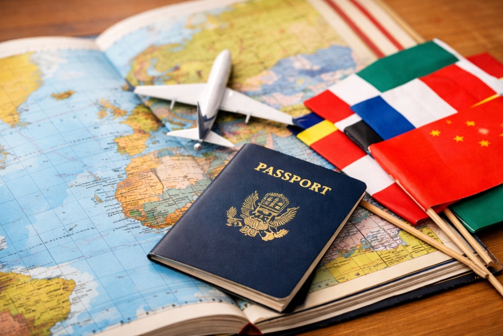 Passport, small airplane model, and international flags placed on an open world map, symbolizing global travel and international education opportunities.