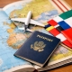 Passport, small airplane model, and international flags placed on an open world map, symbolizing global travel and international education opportunities.